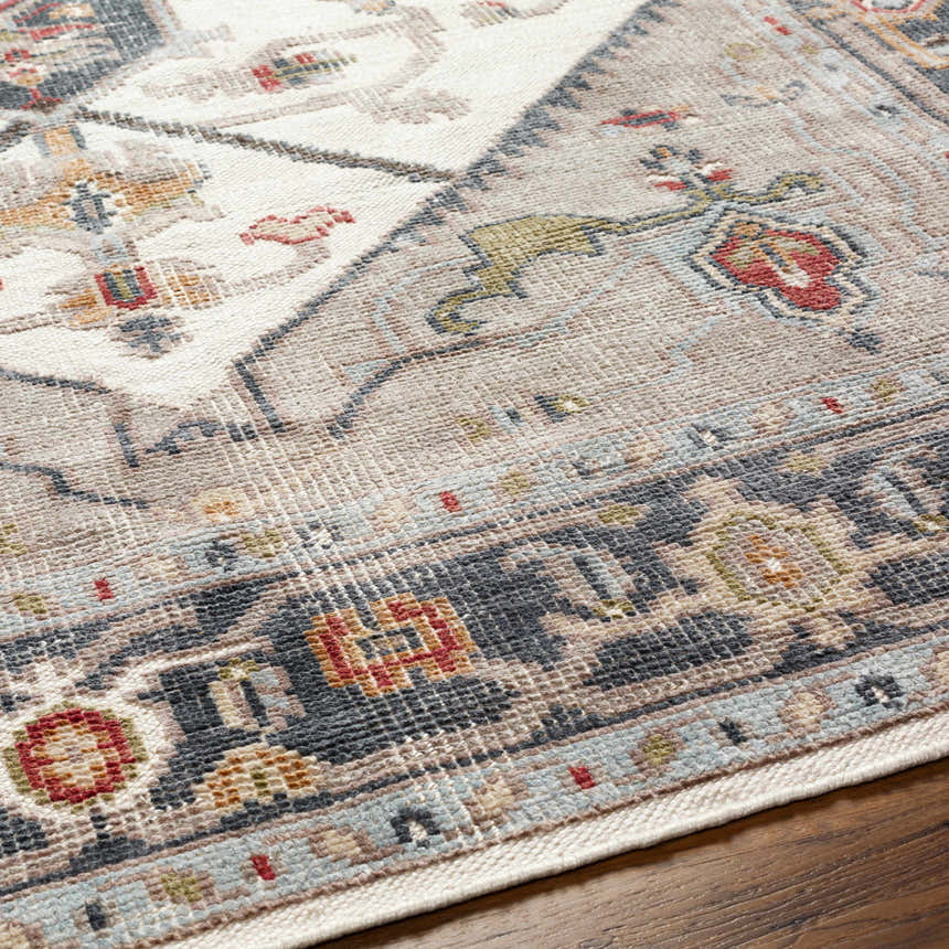 Close up of the Halayhayin Premium Rug featuring a traditional pattern in cream, gray, red, and blue. Texture