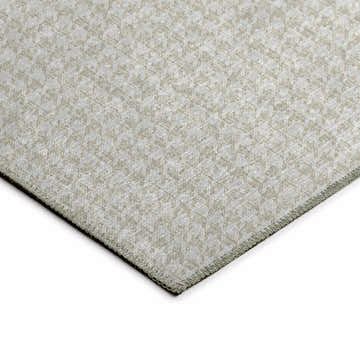 Close-up of the beige and chestnut Dalyn Hinton washable rug, featuring a subtle geometric pattern and textured weave.