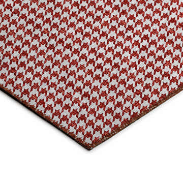 Close-up of Dalyn Hinton HN1 Red Washable Area Rug, featuring a red and off-white houndstooth pattern and a dark border.