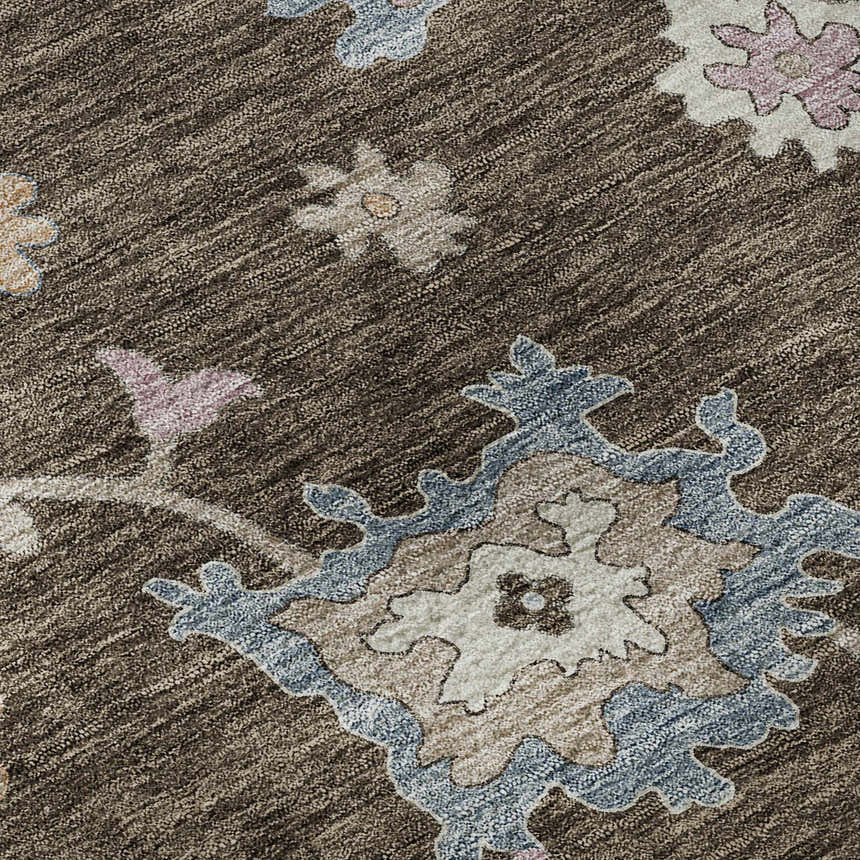 Close-up of Dalyn Luxury Hatay HY4 Chocolate Washable Area Rug. Features beige, blush pink, and blue floral pattern on a brown ground.