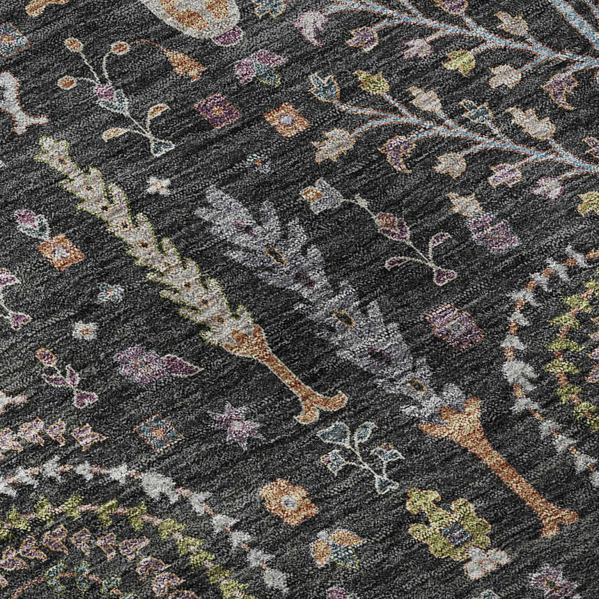 Close-up of Dalyn Luxury Hatay HY5 Black Washable Area Rug. Features floral and plant pattern in black, green, purple, and taupe.