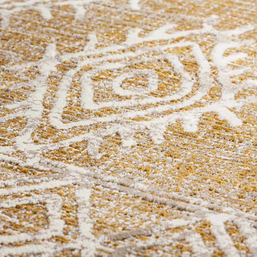 Close-up of the Dalyn Izmir IZ1 Gold Area Rug showing its beige, gold and ivory geometric pattern.