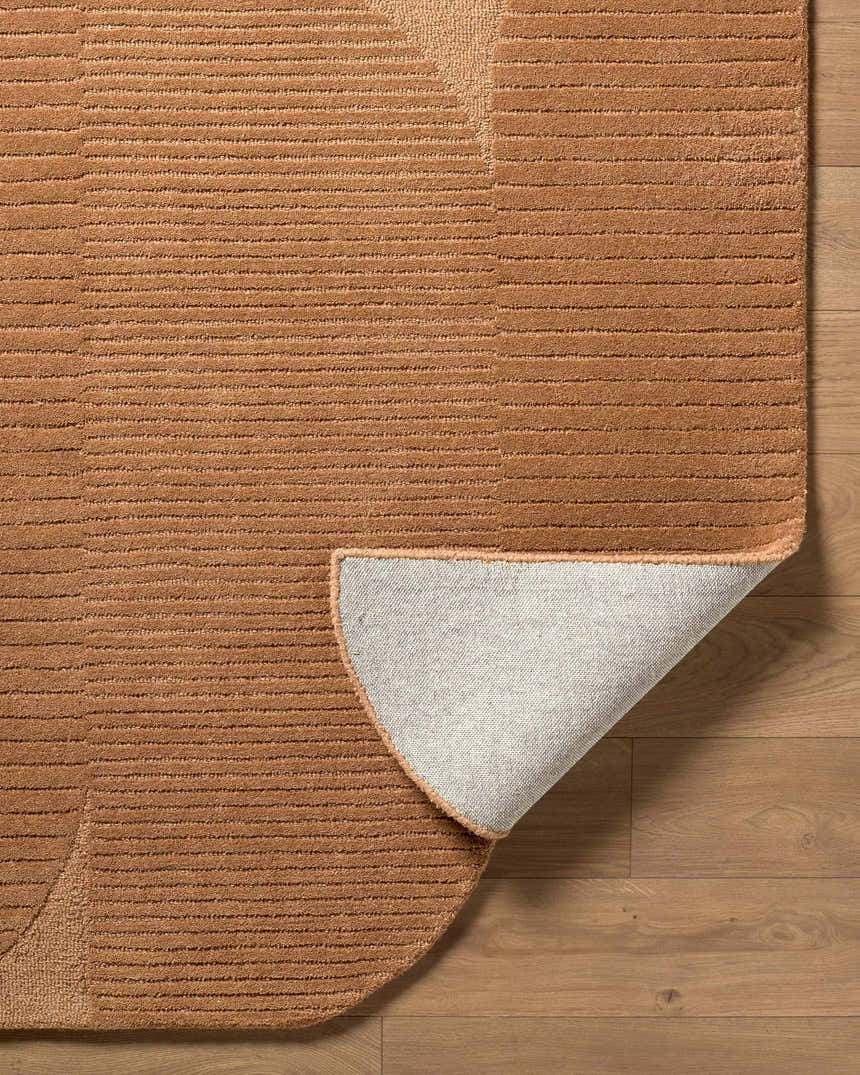 Close-up of the Fihe Abstract Modern Rug showing the texture, sandstone color, and hand-tufted wool construction. Fold