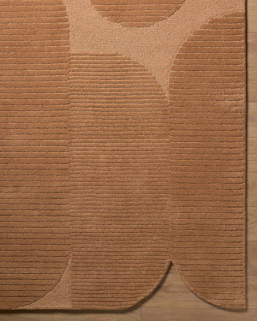 Close up of the Fihe Abstract Modern rug showing its terracotta color, wool texture, and geometric design. Corner