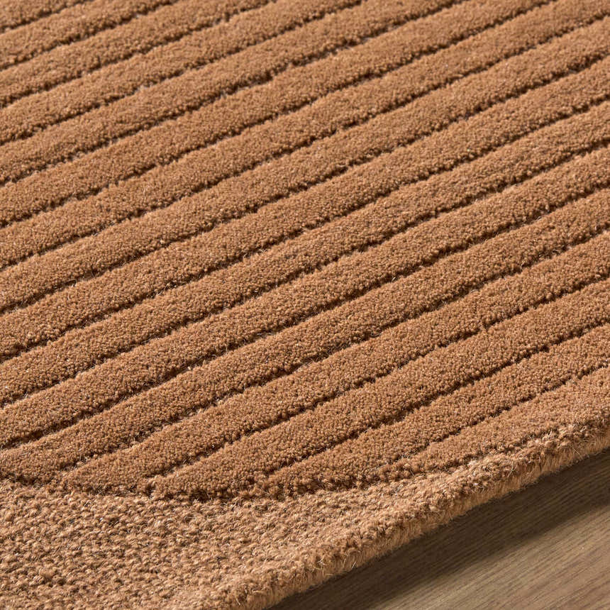 Close up of the Fihe Abstract Modern Rug showing the hand tufted wool texture and ribbed design in terracotta. Texture