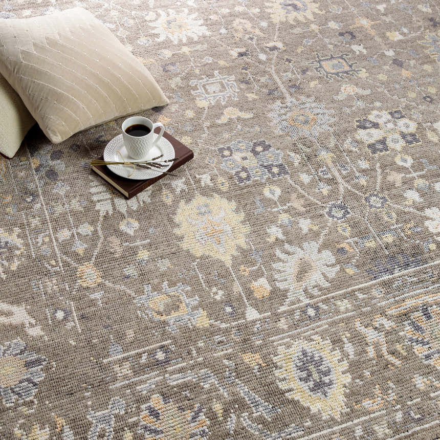 Close-up of the hand-knotted Kajiado Area Rug in charcoal, cream, and coral with a traditional, bohemian pattern. Styleshot