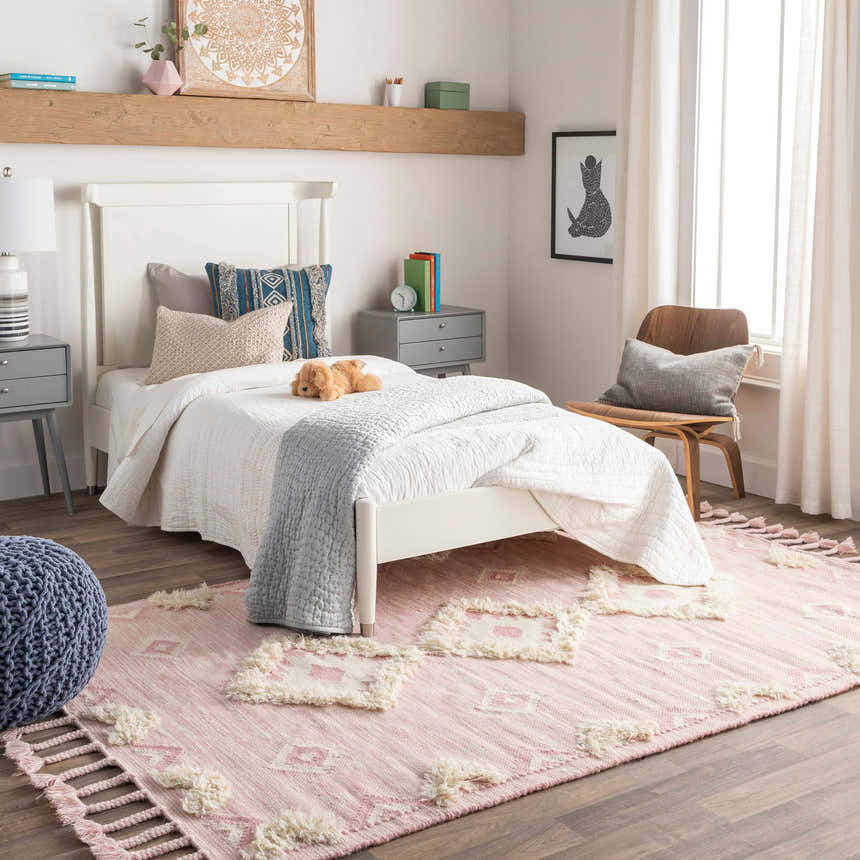 Kids bedroom with white bed and Gardner Pink Wool Tassel Rug, a bohemian style rug with cream accents. Roomscene-Rectangle
