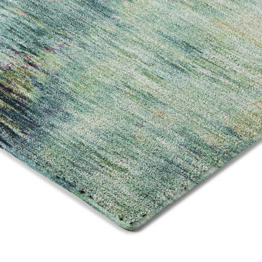 Close-up of the teal Dalyn Luxury Kochi KC1 rug, showing its textured weave and subtle beige, green, and navy accents.