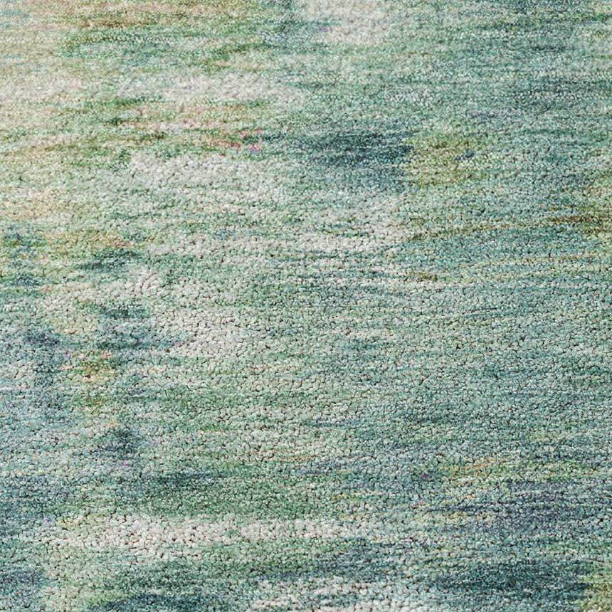 Close-up of the Dalyn Luxury Kochi KC1 Teal Area Rug, showing its texture and beige, green, and teal colors.