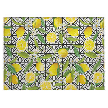 Dalyn Kendall KE5 Ivory rug close-up. Features a lemon, leaf, and white flower pattern on a black geometric background.
