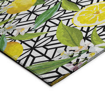 Close-up of the Dalyn Kendall KE5 Ivory Washable Area Rug, featuring a lemon, floral and black geometric design.