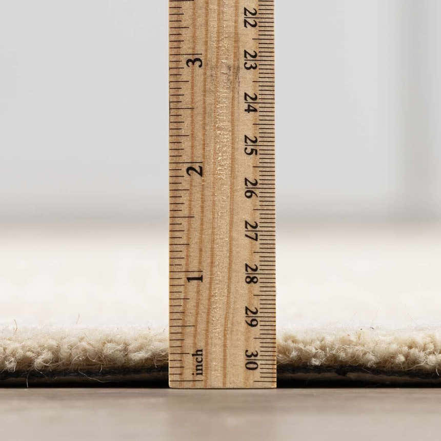 Close-up of the thick pile height of the hand-tufted Kayoko Ivory Area Rug, showing its texture. Pile