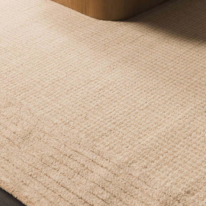 Close up of the hand tufted Kayoko Ivory Area Rug showing its subtle stripe pattern and soft wool texture. Roomscene-Rectangle