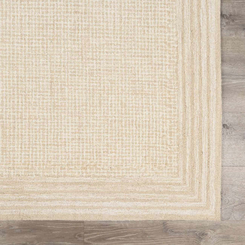Close up of the ivory Kayoko Area Rug showing its textured, grid-like pattern and hand-tufted wool. Swatch