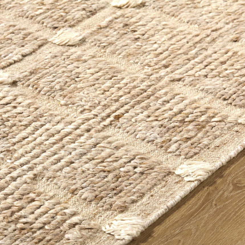Close up of the hand woven Keegan Area Rug, showing beige, sandstone, and taupe wool texture and pattern. Texture