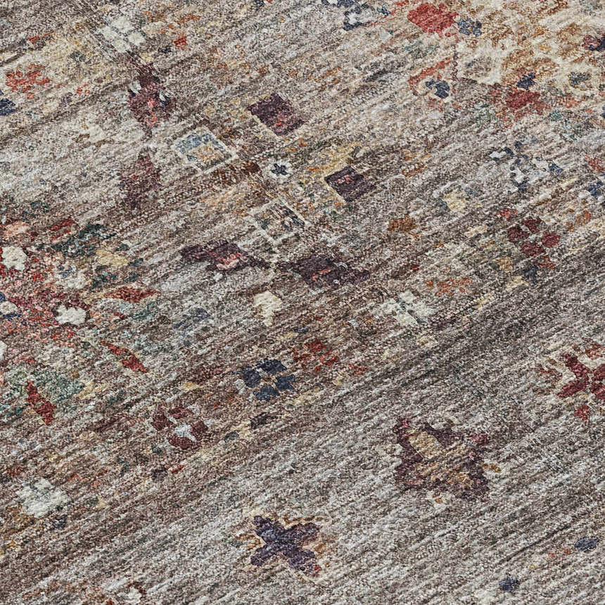 Close-up of the Dalyn Karaj KJ5 Gray Washable Area Rug. Features beige, brown, blue, and paprika colors with a traditional pattern.