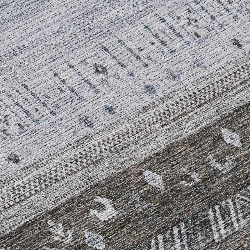 Close-up of the Dalyn Karaj KJ7 Blue Washable Area Rug, featuring a distressed traditional pattern in light blue, gray, and dark brown.