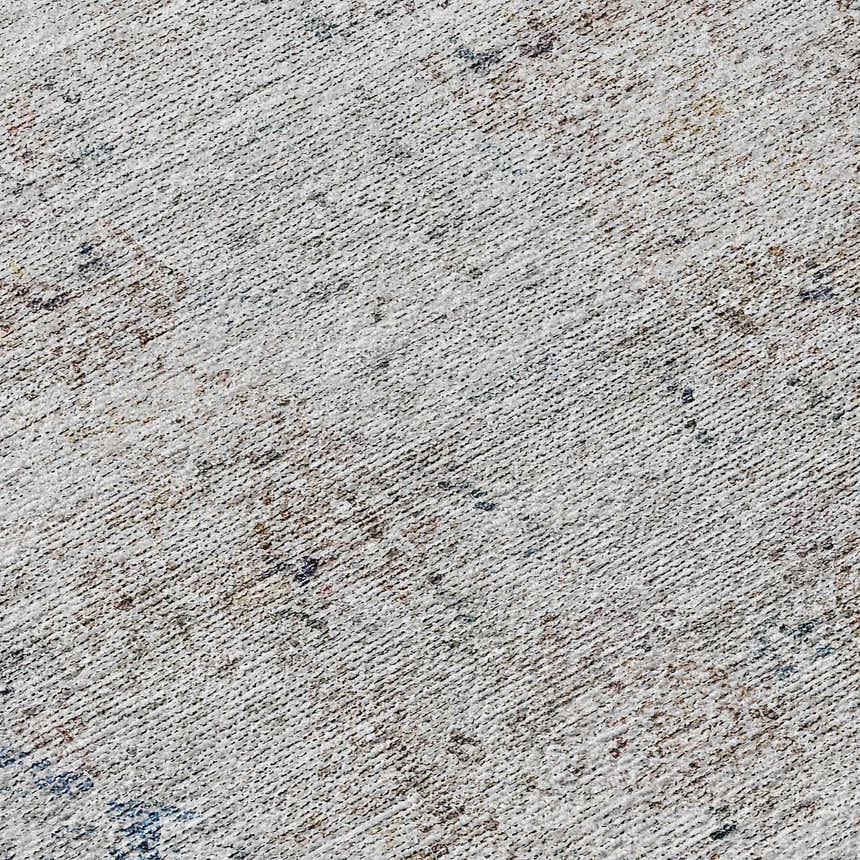 Close-up of Dalyn Karaj KJ8 Blue Washable Area Rug. Ivory, light blue, silver gray, and taupe textured pattern.