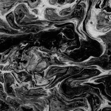 Close-up of the Dalyn Machine Kikiamo KK14 Marble Washable Area Rug, showing its black, marble, and taupe swirling pattern.