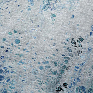 Close-up of Dalyn Machine Kikiamo KK18 Ocean Washable Area Rug. Features light blue, ocean, teal, and taupe abstract pattern.