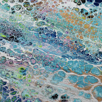 Close-up of Dalyn Kikiamo KK20 Twilight Washable Area Rug featuring a gold, teal, and navy abstract pattern.