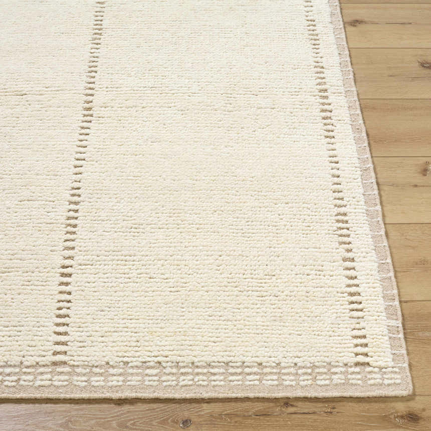Close up of the hand knotted Kimani Area Rug. Ivory wool rug with sandstone accents and a geometric border. Front