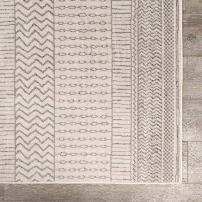 Close-up of the Lascassas Neutral Area Rug, showcasing its geometric pattern in charcoal and light gray tones. Swatch