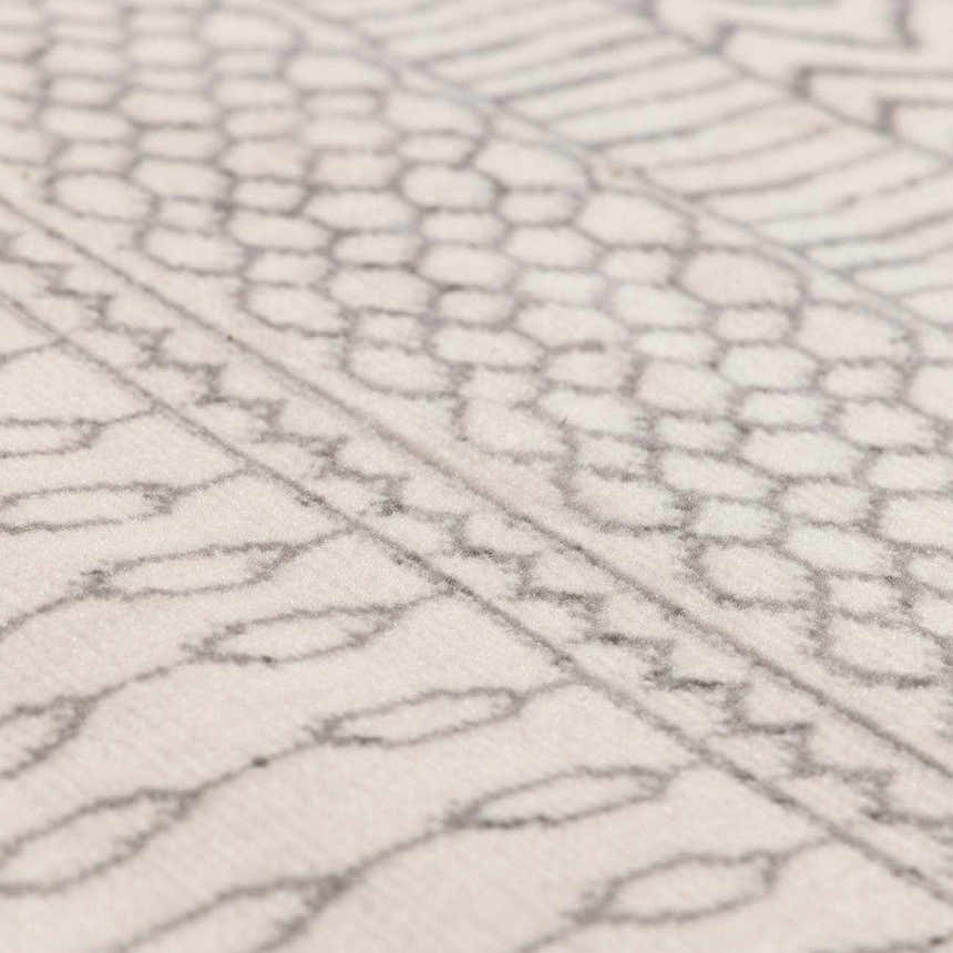 Close-up of the Lascassas Neutral Area Rug featuring a geometric pattern in charcoal and light gray on an off-white base. Texture
