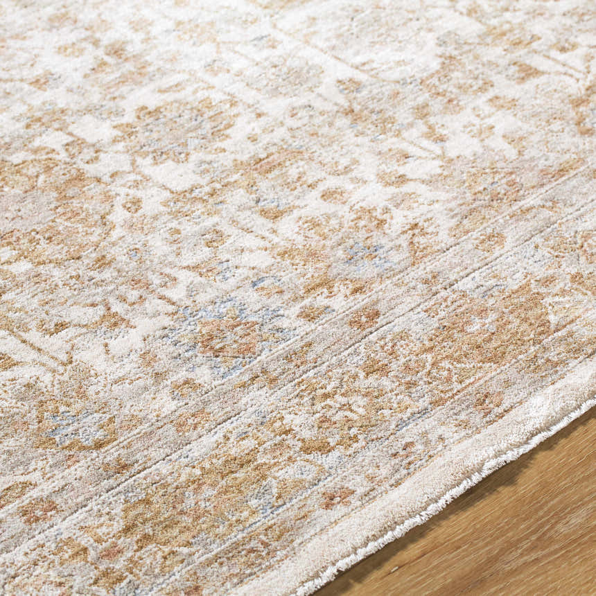 Close-up of the Andres Sage Area Rug. Farmhouse style rug in cream, light brown, sage, and blue floral pattern. Texture