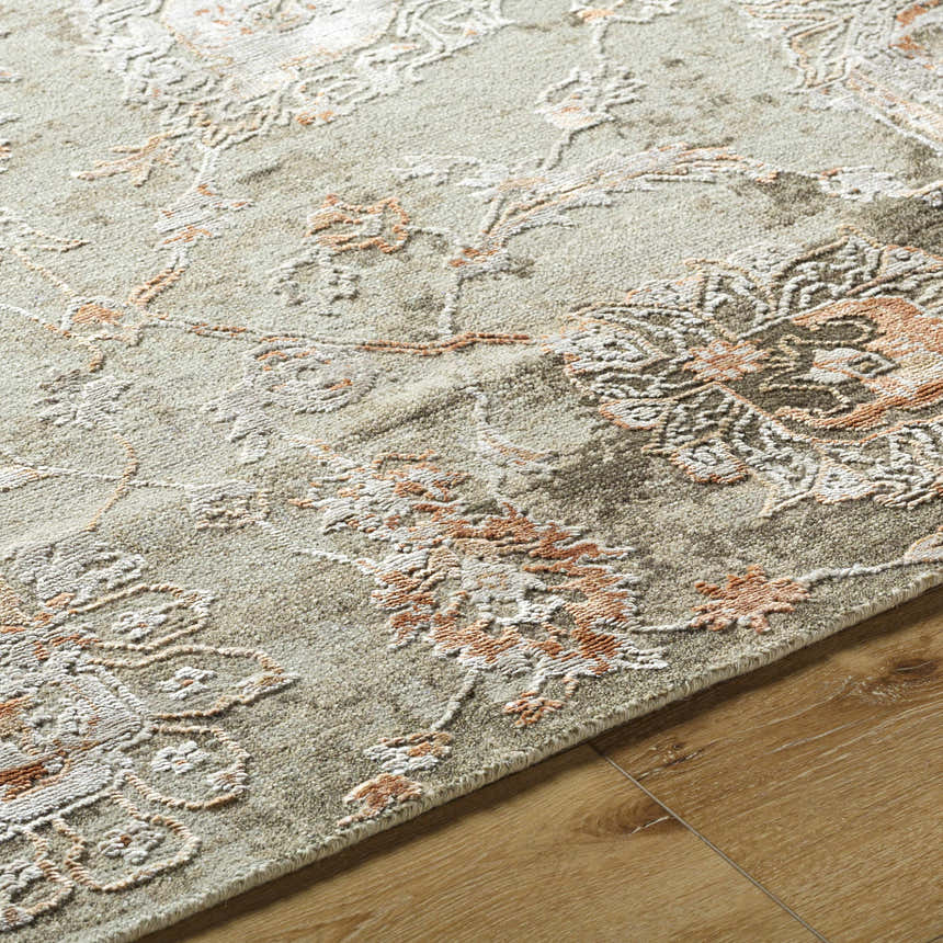 Close-up of the Limay Premium Wool Rug, showcasing its floral pattern in brick red, beige, and olive tones on a textured wool surface. Texture