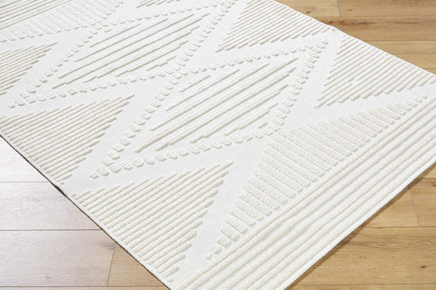Close up of the Annika Beige 3D Washable Area Rug. The rug has a geometric pattern and a textured, raised design. Corner
