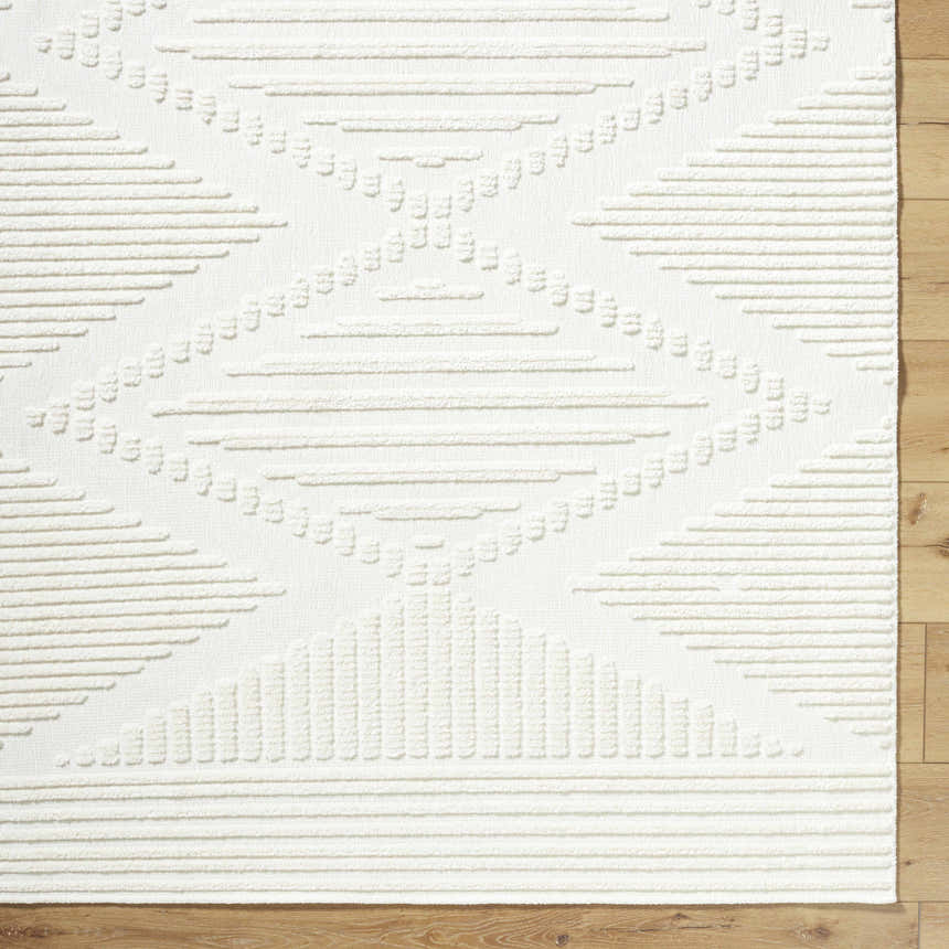 Close-up of the Annika Beige 3D Washable Area Rug, showing its geometric pattern and textured, off-white pile. Corner