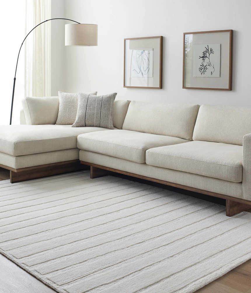 Living room with cream sofa and Aurex Cream Stepped Arch Art Deco Wool Handmade Area Rug. Roomscene-Rectangle