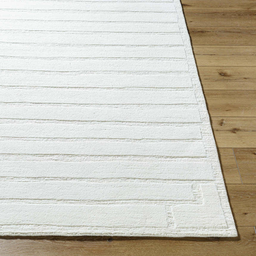 Close up of the Aurex Cream Stepped Arch Art Deco Wool Rug showing texture and pattern on wood flooring. Front