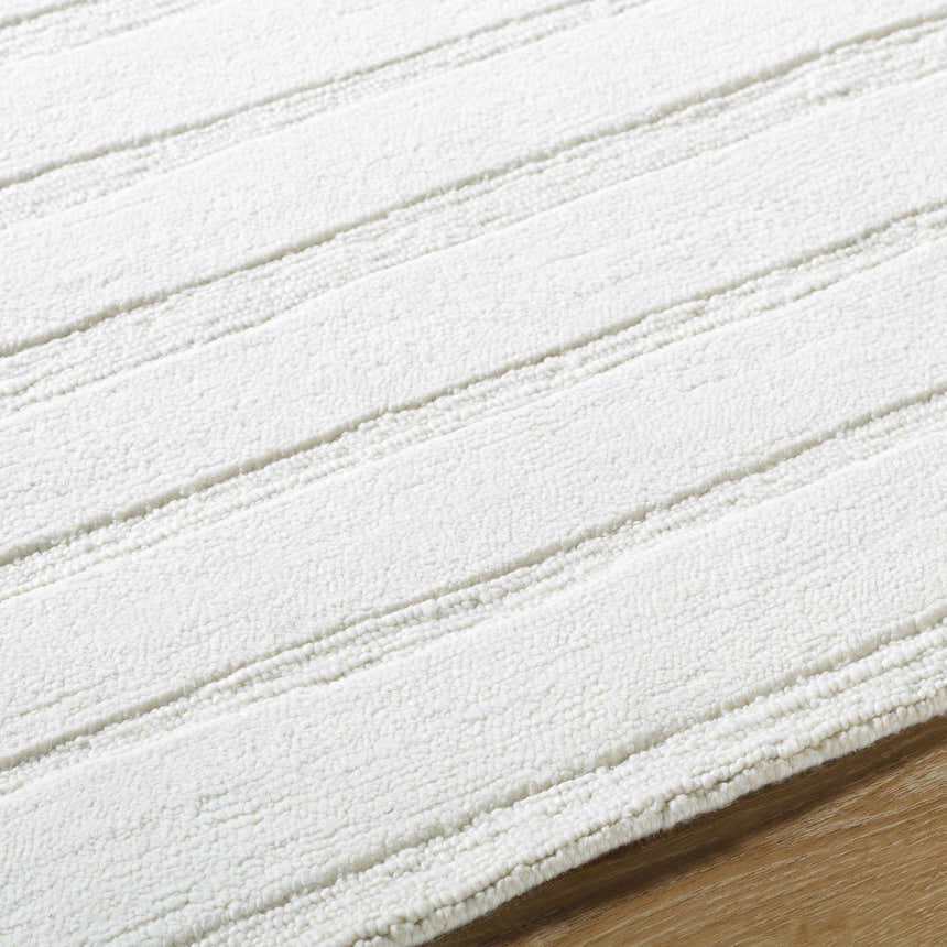 Close up of the Aurex Cream Stepped Arch Wool Rug showing its texture and stepped design. Texture