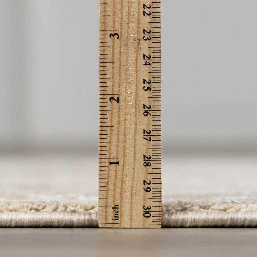 Close-up of the thick pile height of the Airlia Cream Luxe Area Rug, showing its soft texture and quality construction. Pile