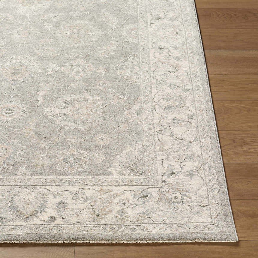 Close up of the Alinae Area Rug showing its traditional floral pattern, cream, green, and slate blue colors. Front