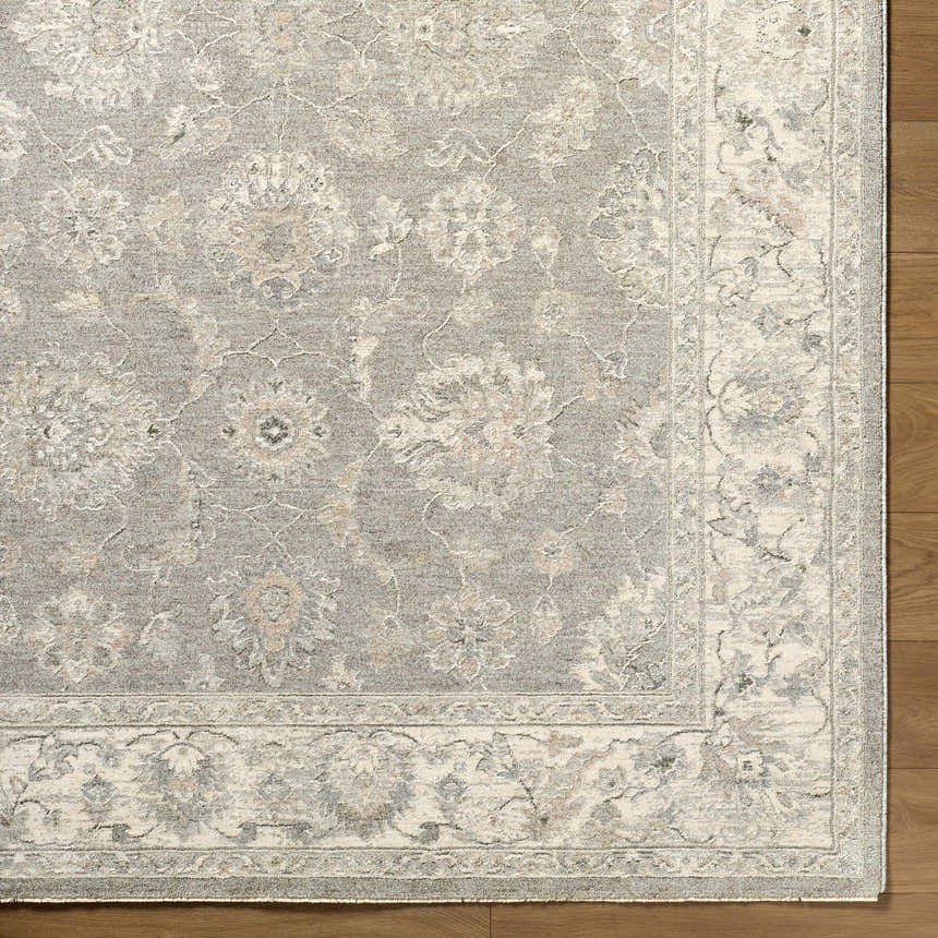 Close up of the Alinae Area Rug showing cream, green, and slate blue floral pattern and traditional design. Corner