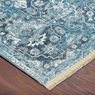 Close-up of the Dalyn Marbella MB4 Navy Washable Area Rug. Features a traditional floral pattern in navy, taupe, and chestnut.