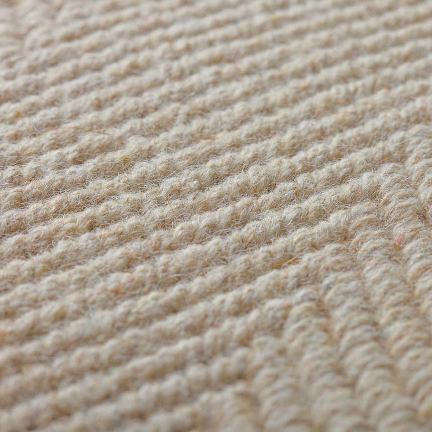 Close-up of the textured, beige Dalyn Monaco Sisal MC200 Linen Area Rug showing its hand-loomed wool and cotton construction.