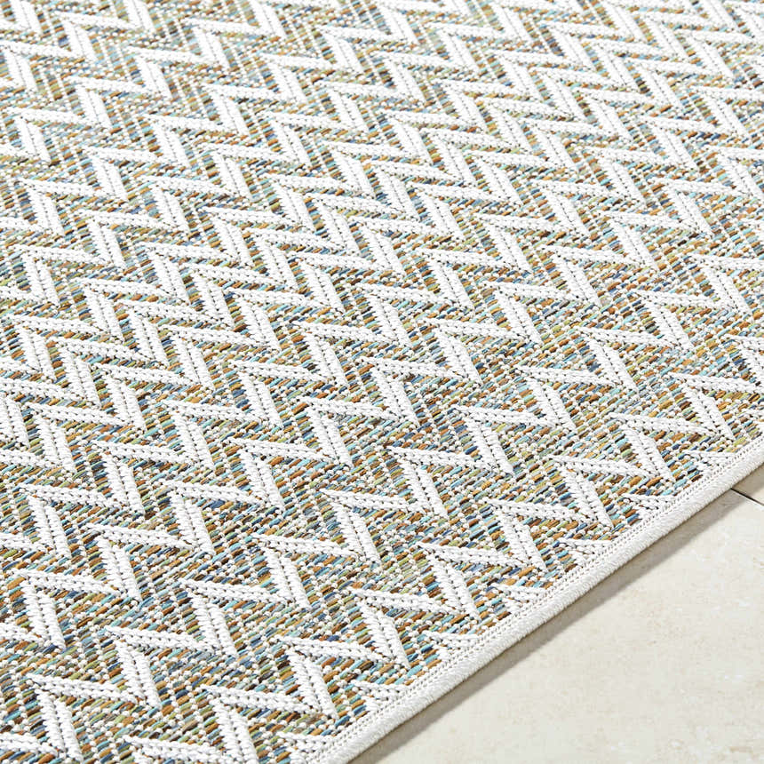 Close-up of the Alazne Ivory Area Rug showing the ivory geometric pattern and sage, tan, and taupe woven texture. Texture