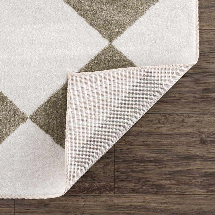 Close-up of the Ulric Green Diamond Washable Area Rug showing the cream and green diamond pattern and non-slip backing. Fold