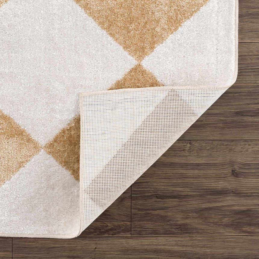 Close-up of the Ulric Light Brown Diamond Washable Area Rug showing its diamond pattern and non-slip backing. Fold