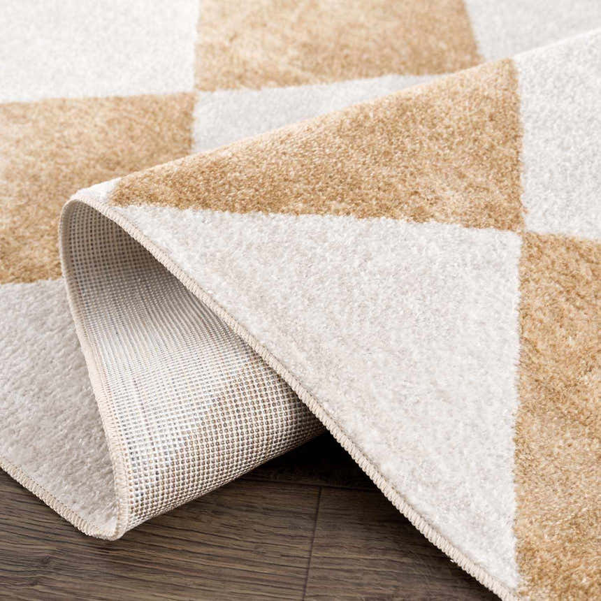 Close-up of the Ulric Light Brown Diamond Washable Area Rug, showing cream and light brown square pattern and rug backing. Fold