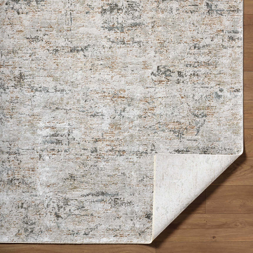 Close-up of the Meral Thick Luxe Boutique Rug. Southwestern style rug in charcoal, cream, brown and gray tones. Fold