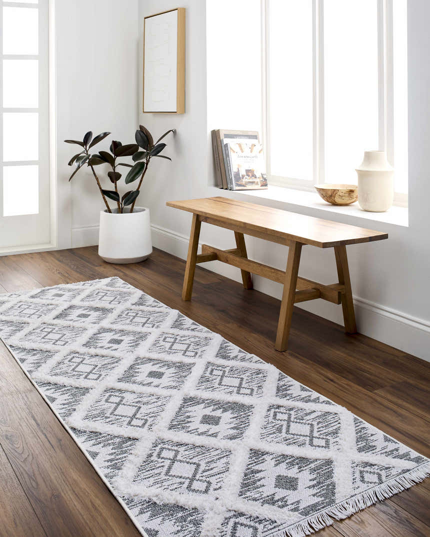 Entryway with Moto Area Rug runner in arctic stone and gray, wooden bench, and white accents. Roomscene-Runner