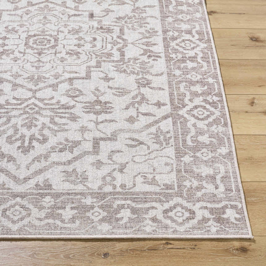Close-up of the Ansgar Washable Wool Area Rug. Beige and taupe floral pattern on a hand woven, rectangular rug. Front