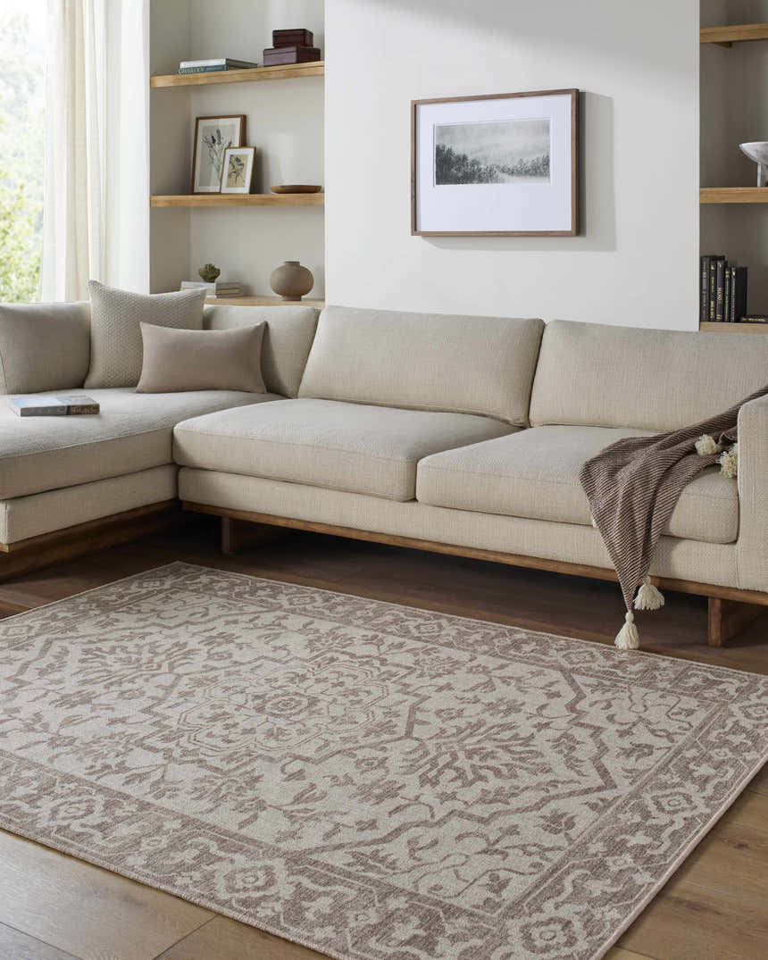 Living room with beige sectional and the beige and taupe Ansgar Washable Wool Area Rug with a traditional floral pattern. Roomscene-Rectangle
