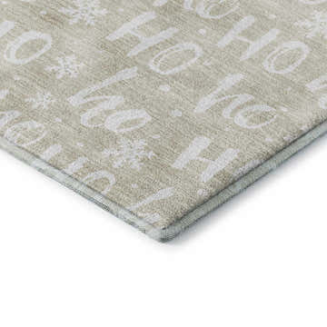 Close-up of the Dalyn Luxury Merry & Bright rug. Beige rug with white Ho Ho Ho and snowflake pattern. Washable, indoor/outdoor.