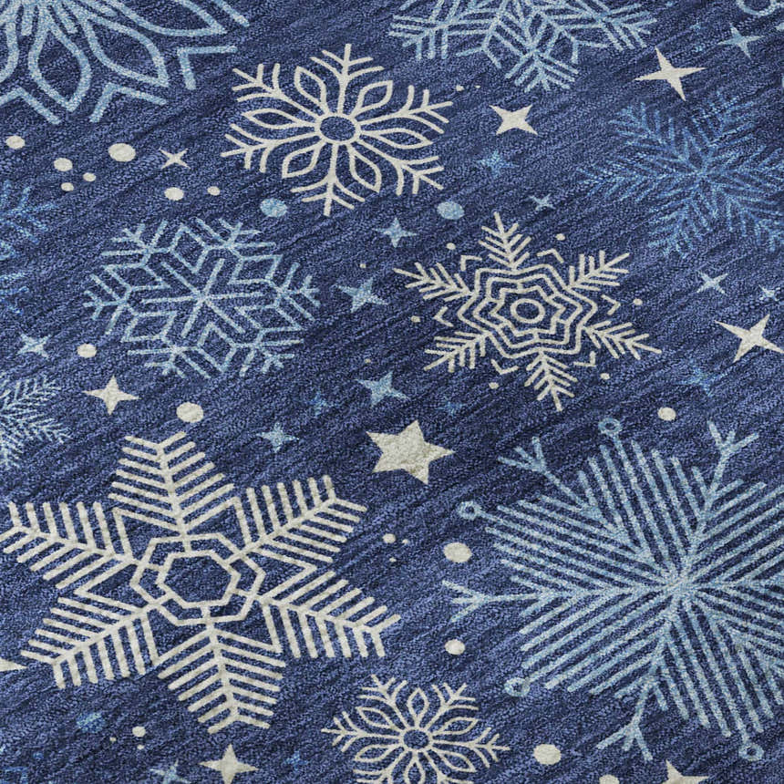 Close-up of Dalyn Luxury Merry & Bright Navy rug. Features snowflake and star pattern in denim, sky blue, and white.